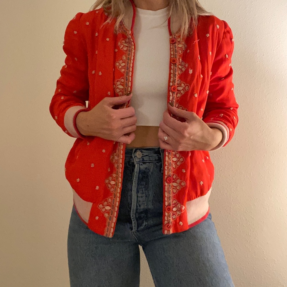 Red Anthropologie bomber jacket.